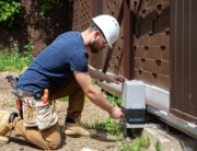 An electrician making electrical ground connection