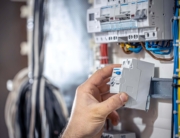 A hand on circuit breaker in the electrical panel